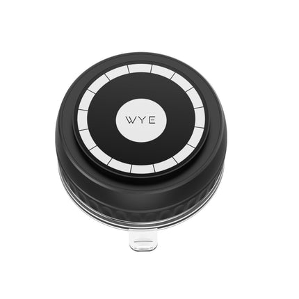 Black circular device with a label on a white background