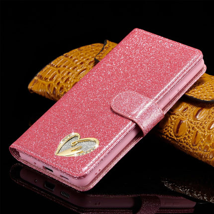 Pink glittery phone case with a gold heart design on a black background for Samsung S26 Ultra