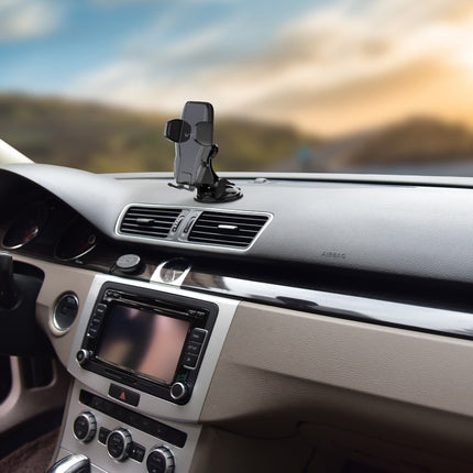 Car dashboard with a GPS device mounted on the air vent.